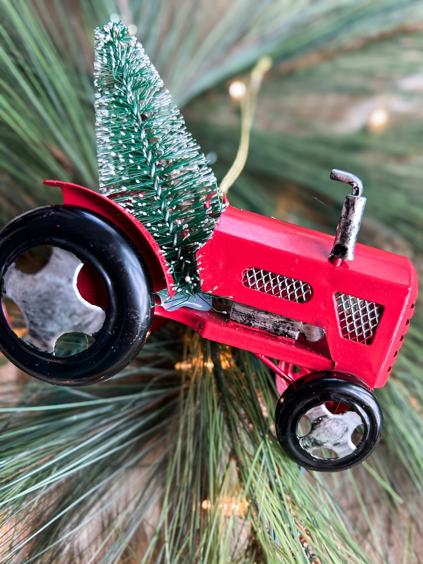 A shot of a Red tractor ornaments on tree