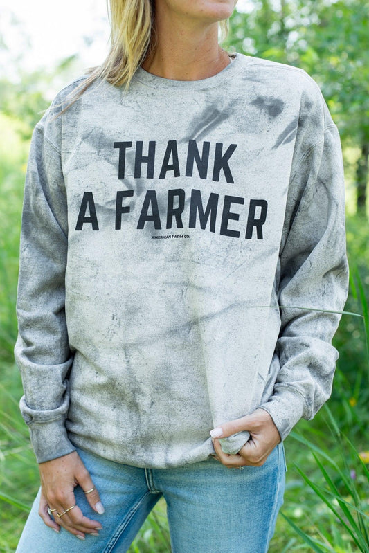 Rugged grey tie-dye crewneck with bold 'THANK A FARMER' text, relaxed fit, rural heritage style by American Farm Company