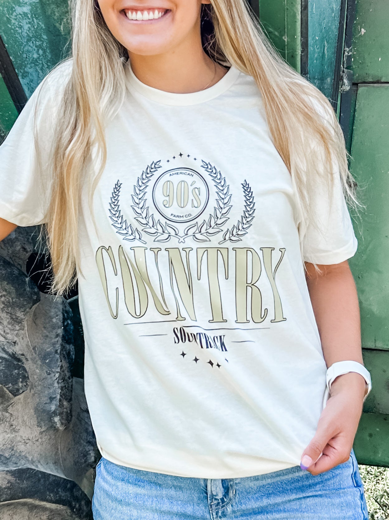A woman wearing 90s Country T-shirts in a close up shot