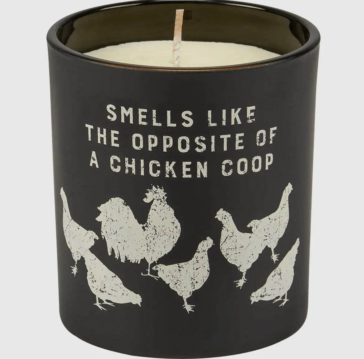 Matte black candle with distressed white chicken silhouettes and rustic 'Smells Like the Opposite of a Chicken Coop' text, evoking American Farm Company’s rural heritage vibe.