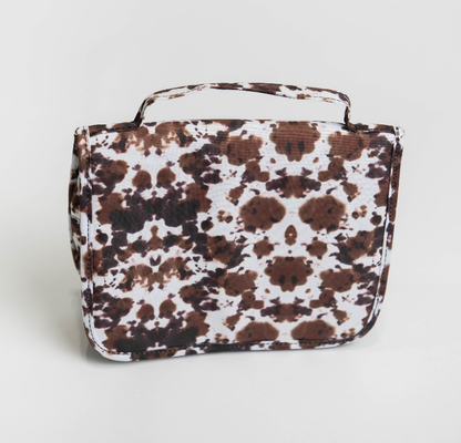 Picture of a Cow Print Make Up Bag in white backdrop