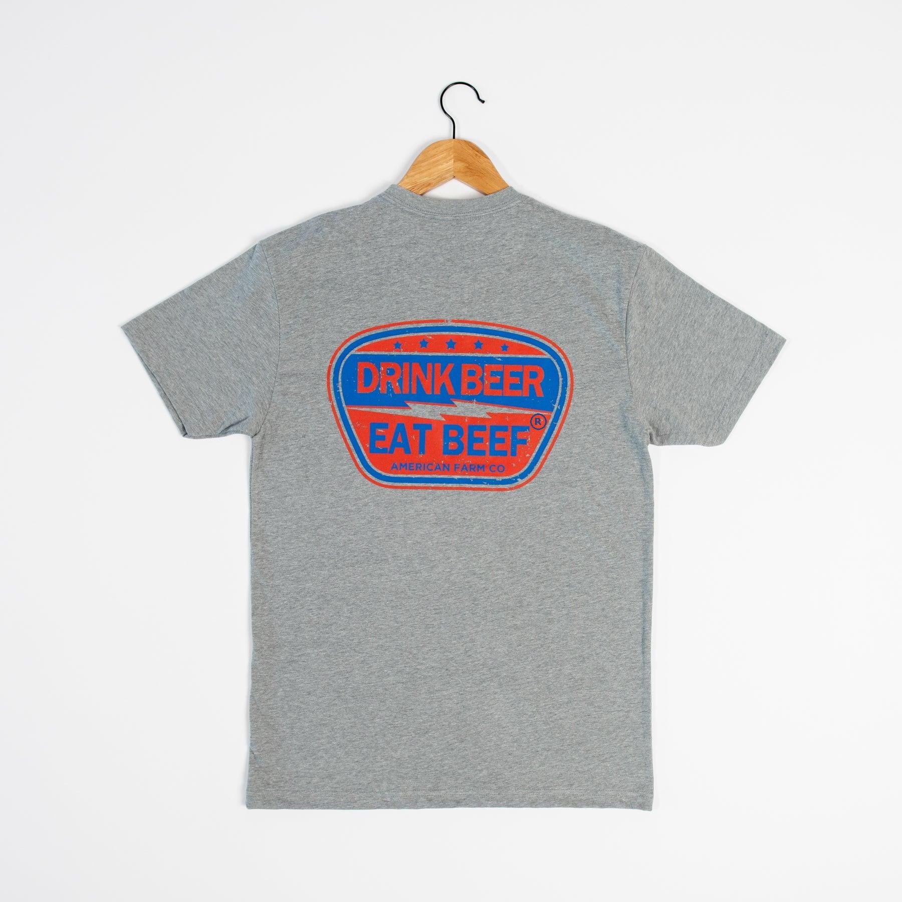 Heritage-inspired heather gray rural graphic tee with bold red and blue 'Drink Beer Eat Beef' emblem, American Farm Company legacy apparel.