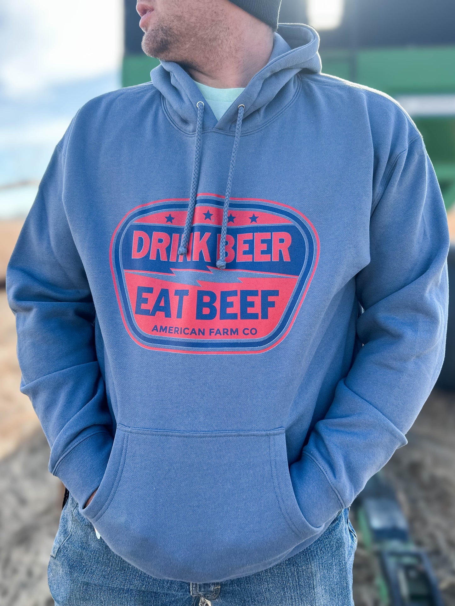 Another shot view of a man wearing a Eat Beef Hoodie in the field