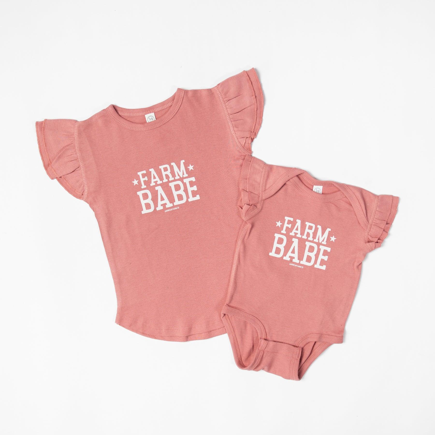 Mauve ruffle sleeve toddler tee and baby onesie with bold 'Farm Babe' text, celebrating rural heritage fashion by American Farm Company.