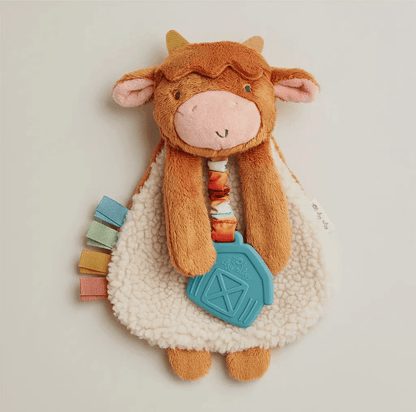 Plush highland cow lovey with soft sherpa body, heritage-inspired barn teether, and colorful ribbon tags, evoking American Farm Company's rural legacy.