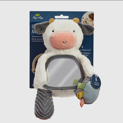 Plush cow sensory toy with mirror belly, soft textured fur, pastel earth tones, reflecting American Farm Company's dedication to rugged rural heritage and agricultural legacy.