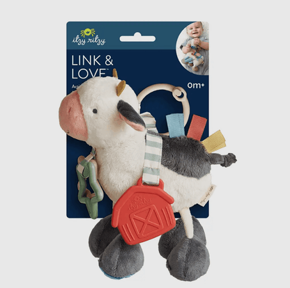 Plush cow activity toy with heritage-inspired barn teether, soft textures, and farmhouse charm for rural family lifestyle.