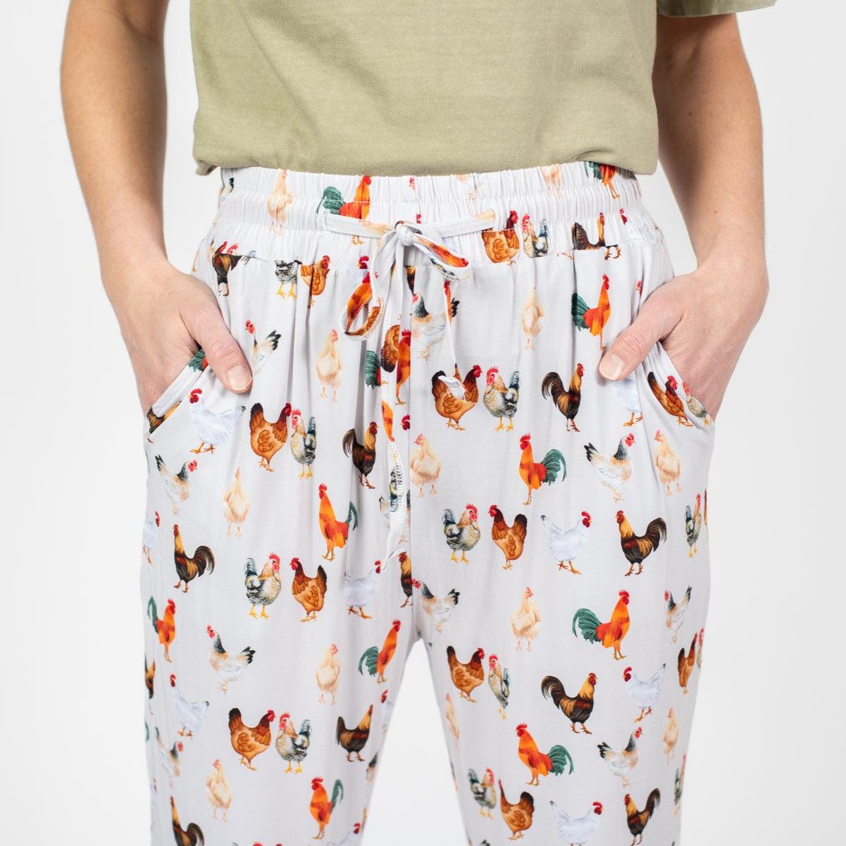 Relaxed fit white pajama pants with colorful rooster and hen print, soft drawstring waist, celebrating American Farm Company's rural heritage style.