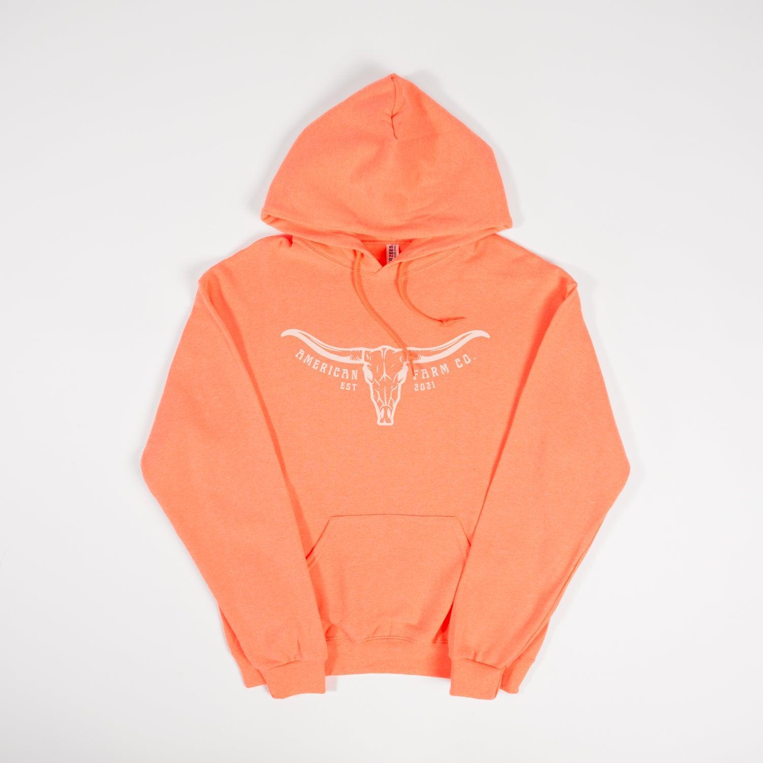 Heritage-inspired neon orange hoodie in heavyweight cotton with longhorn skull graphic, American Farm Co. rural workwear.