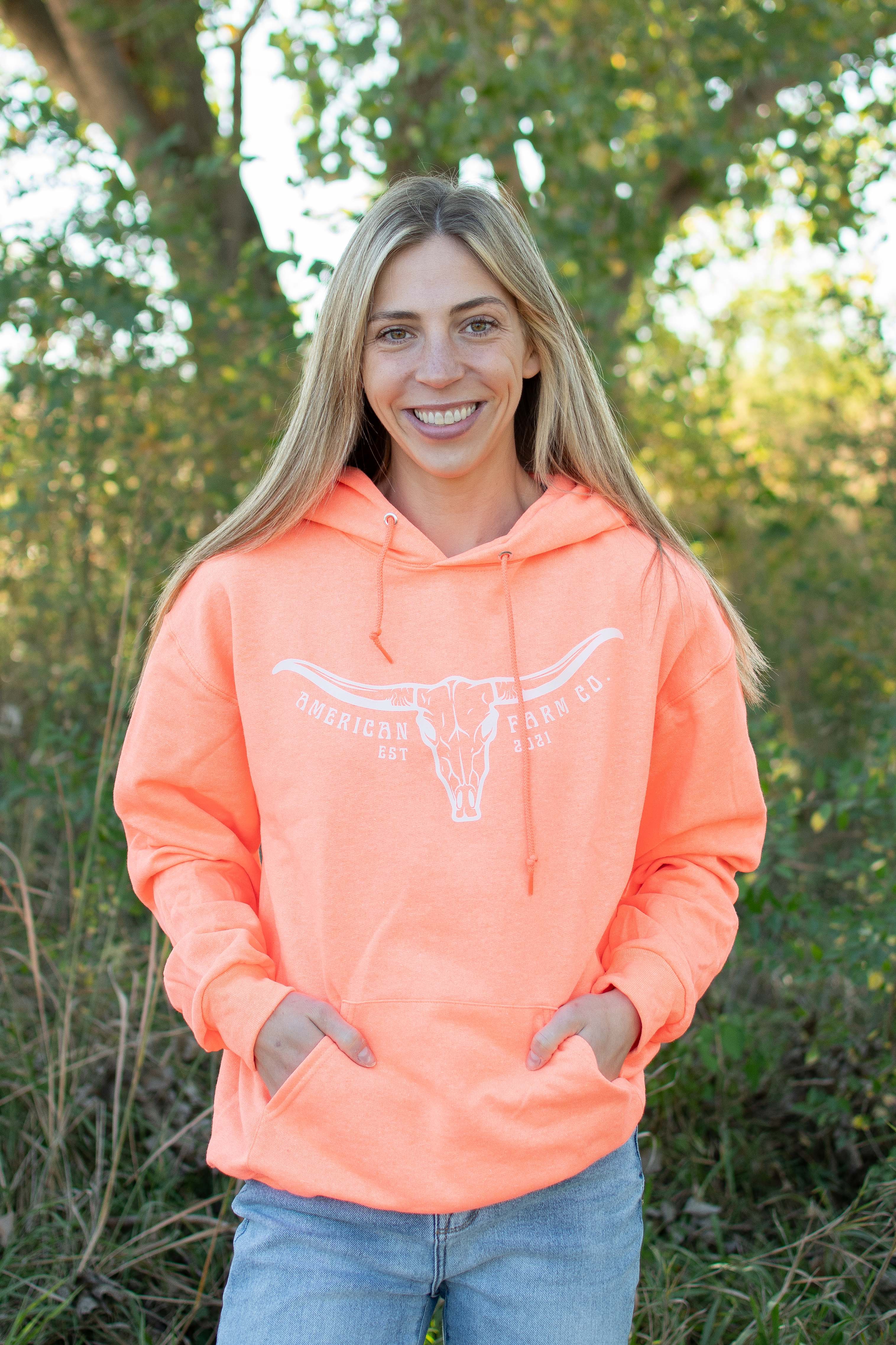 Neon orange relaxed fit hoodie with steer skull heritage graphic, American Farm Co. rural apparel