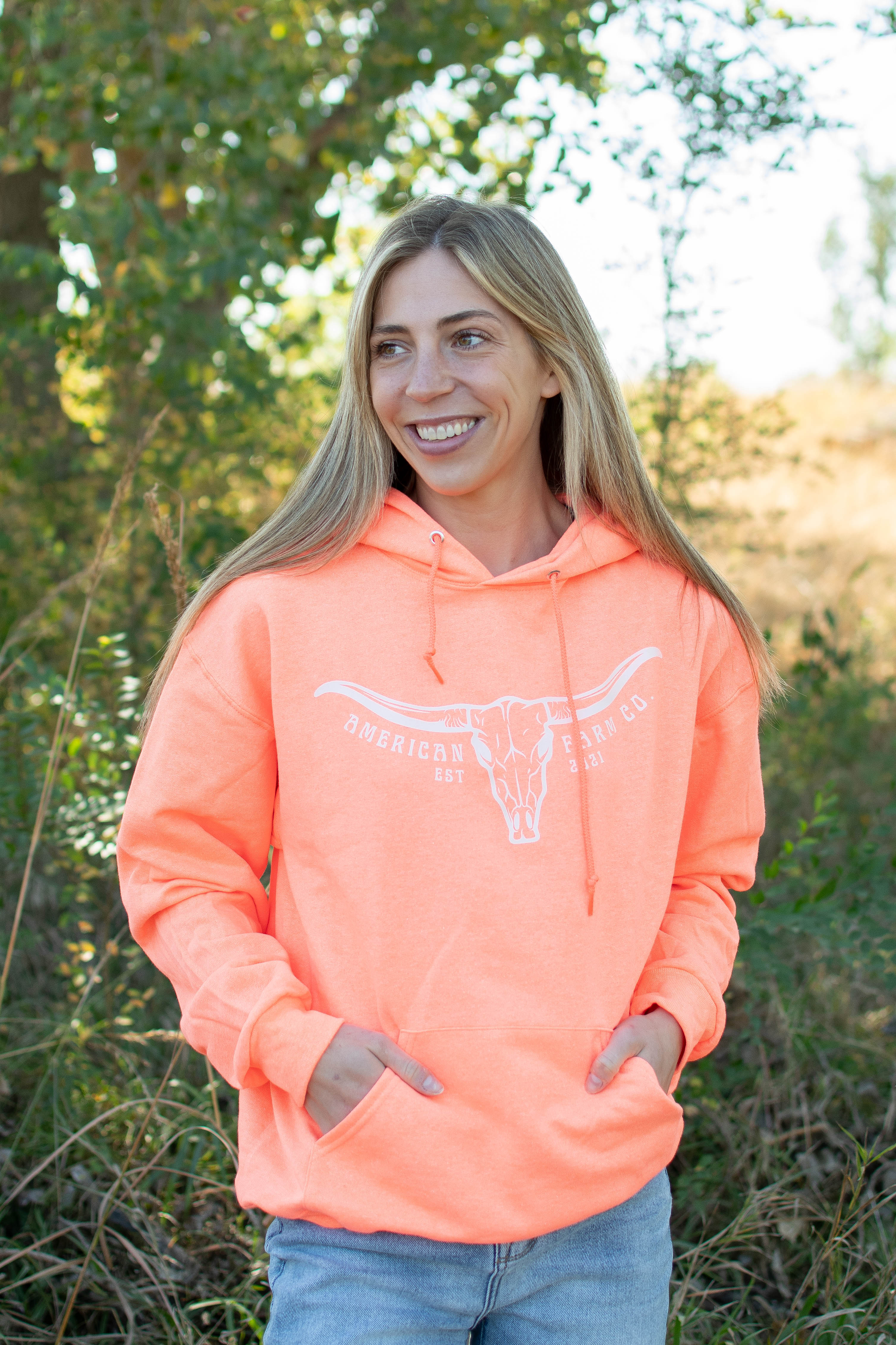 Neon orange relaxed fit hoodie with white longhorn skull graphic, heritage rural loungewear from American Farm Co.