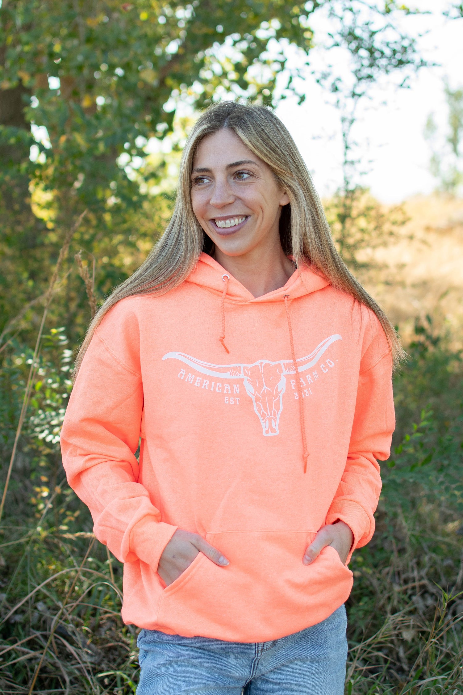 Neon orange relaxed fit hoodie with white longhorn skull graphic, heritage rural loungewear from American Farm Co.