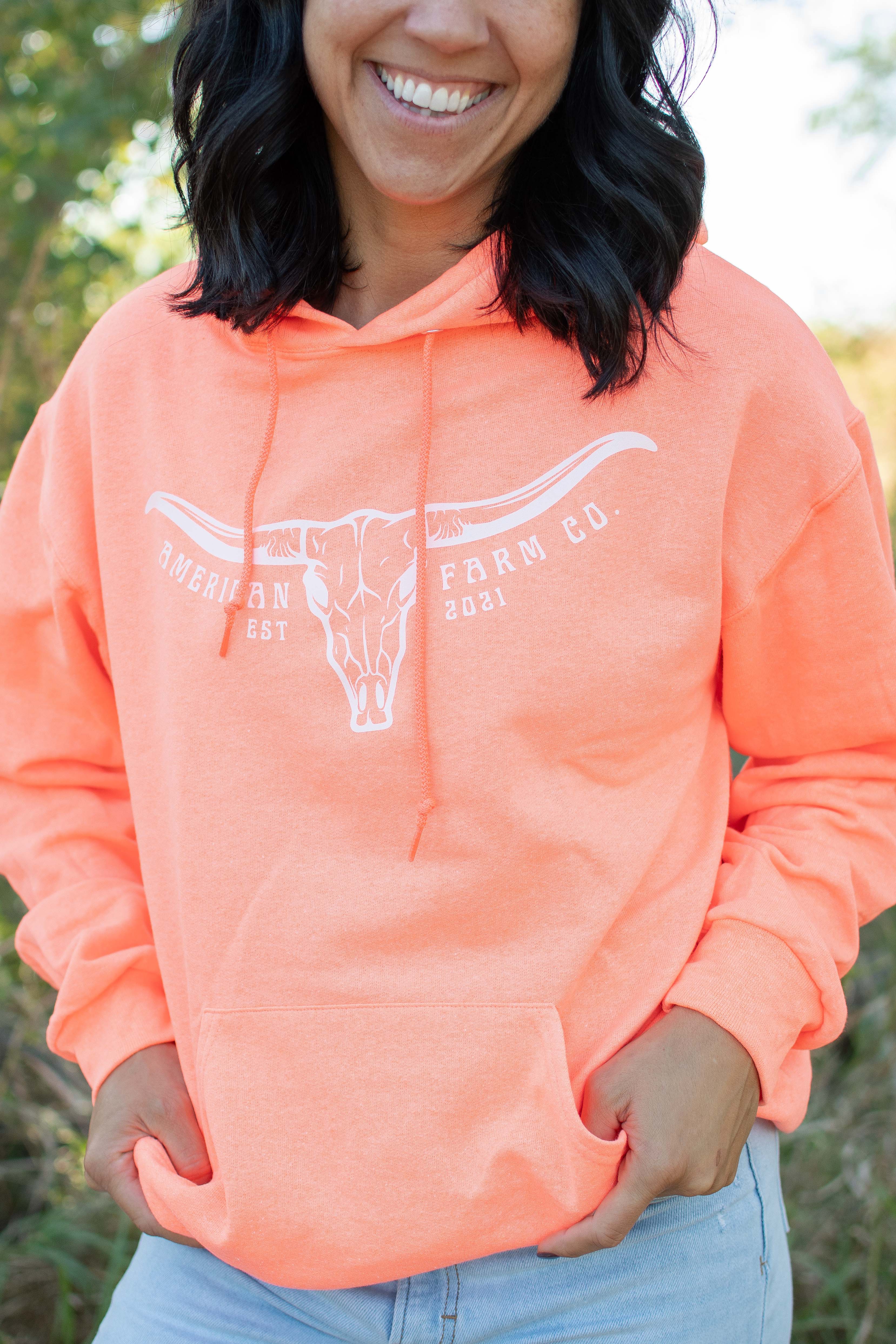 Relaxed fit neon orange hoodie with steer skull graphic, American Farm Co. rural heritage apparel