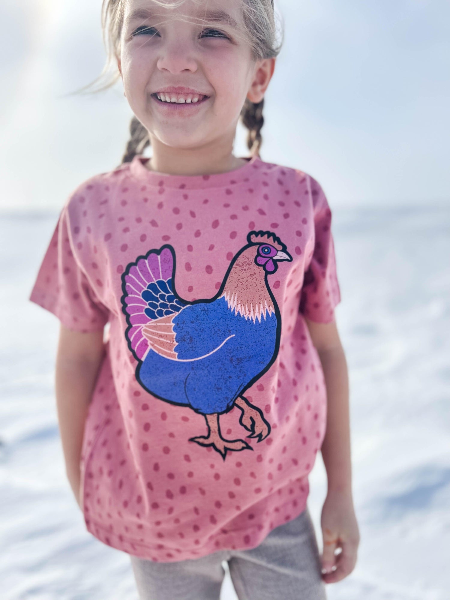 Relaxed fit girls’ pink polka dot tee with bold retro blue chicken graphic, celebrating rural heritage fashion from American Farm Company