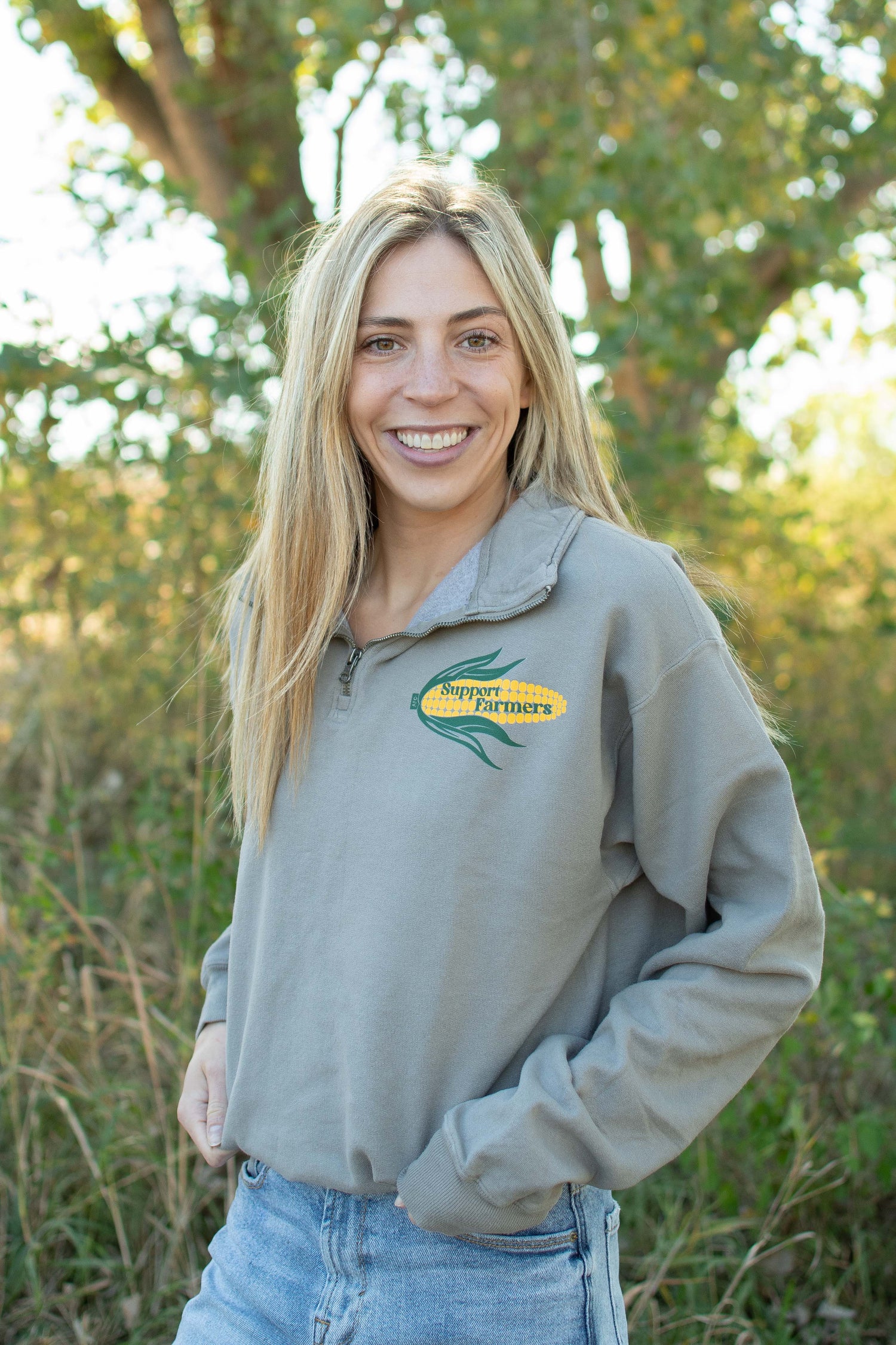 Heritage-inspired light gray quarter-zip pullover with bold corn graphic and 'Support Farmers' text, rugged rural farmstead apparel by American Farm Company