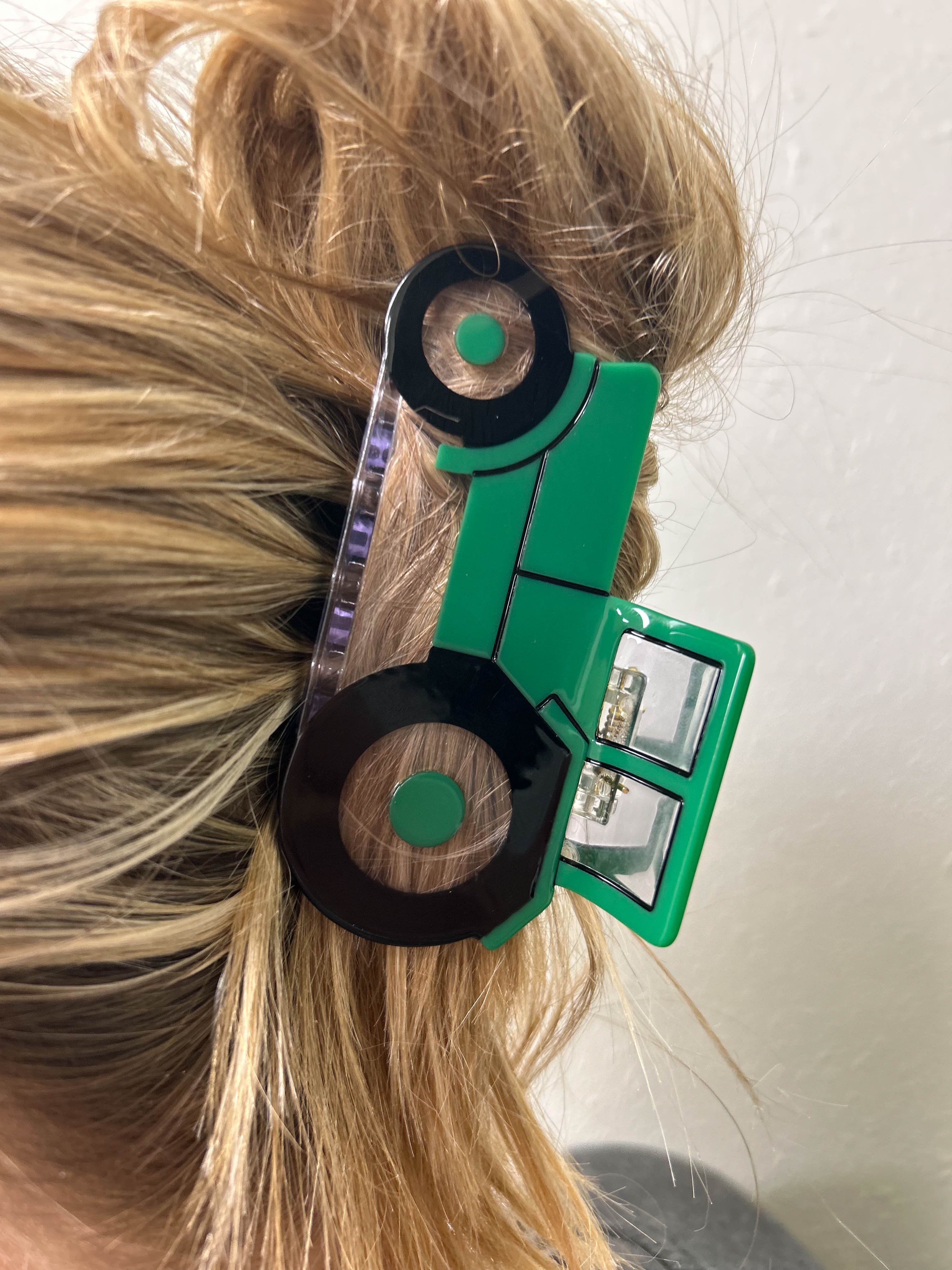 Image of a woman's hair adorned with a Green Tractor Hair Clip