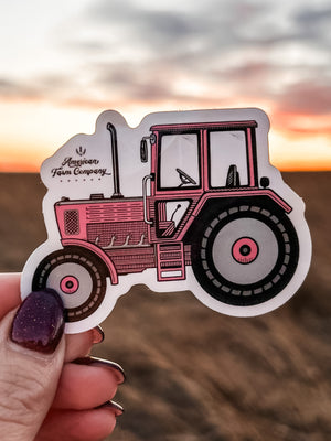 Pink Tractor Stickers in the hands of a woman, showcasing its eye-catching design