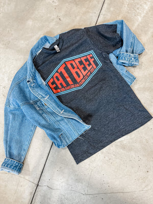 An image of an Eat More Beef Sign flat lay paired with a denim jacket