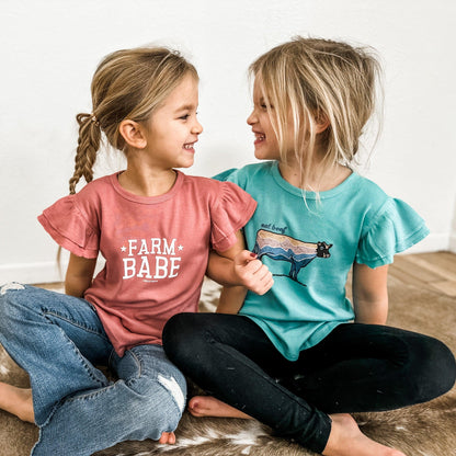 Mauve ruffle-sleeve toddler shirt with 'Farm Babe' heritage graphic, relaxed fit cotton, celebrating rural legacy from American Farm Company.