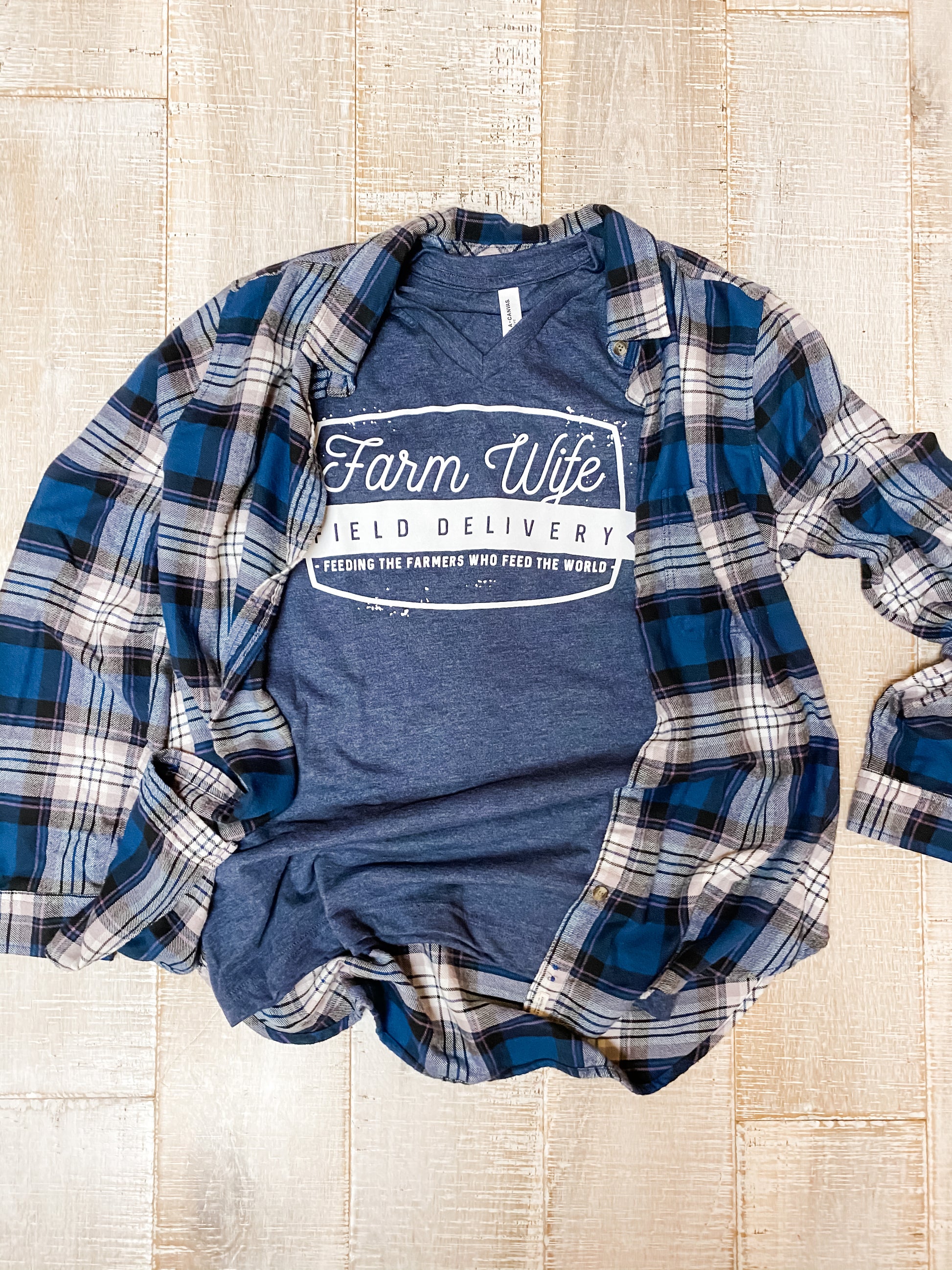 Potential outfit for woman with navy farm wife delivery v neck tee and plaid long sleeve shirt over top