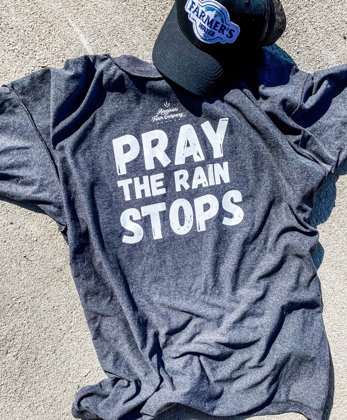 A photo of Pray For Rain Reversible Shirt adorned with a cap for added flair.